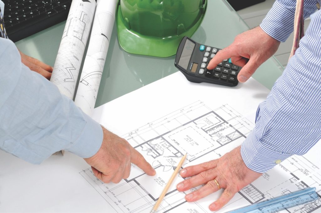 Renovation contractors reviewing blueprints
