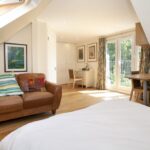 Bright, modern loft conversion with cozy seating, natural light, and elegant decor. Perfect for added space and style.