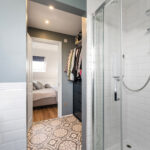 Modern loft conversion with ensuite shower and bedroom, showcasing space optimization and stylish design.