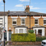 Victorian brick house with loft conversion skylights, showcasing potential home expansion and value increase.