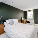 Large double bed in an L shaped loft conversion bedroom