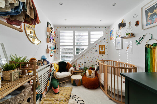 Child's playroom and bedroom with toys in a L shaped loft conversion