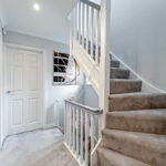 Modern loft conversion staircase with plush carpeting and sleek railings, enhancing home design and functionality.