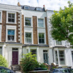Residential building with a loft conversion and two dormer windows, enhancing urban living space and style.