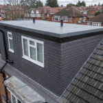 Modern loft conversion with flat roof on suburban home, enhancing space and value.